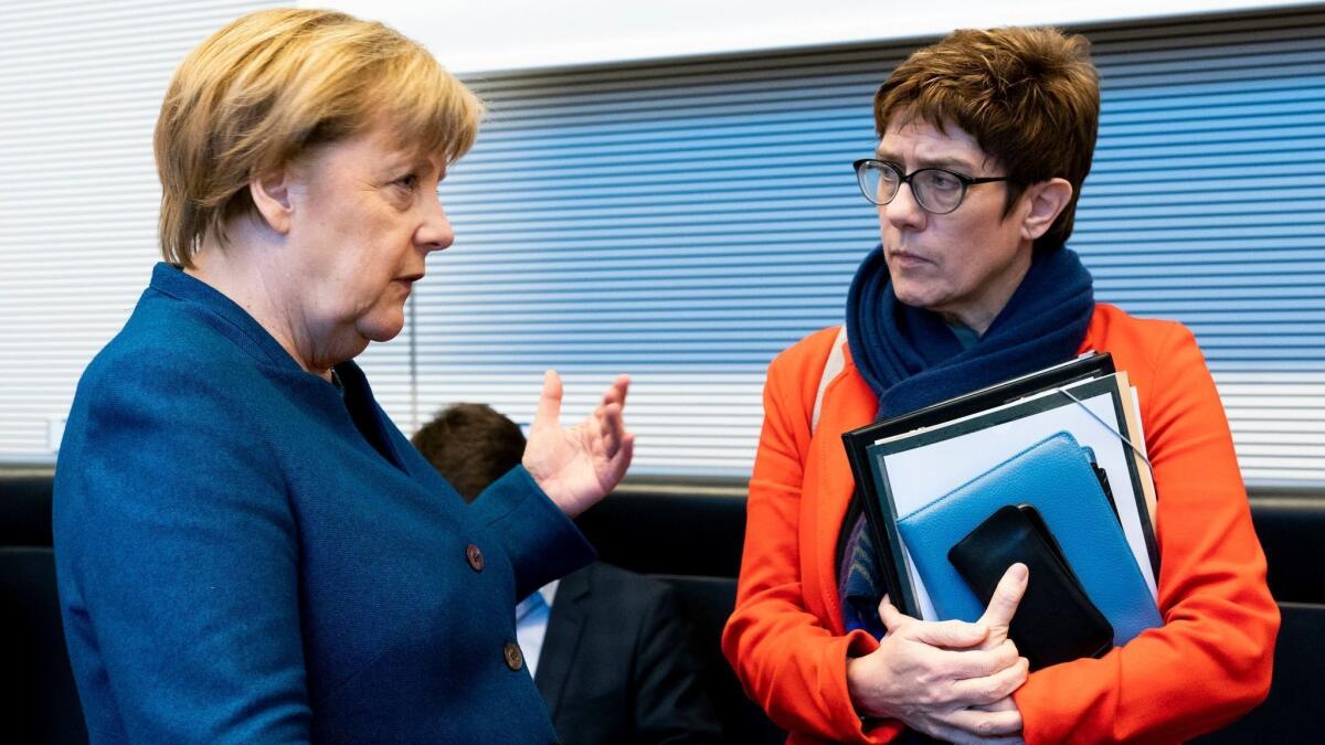 German Chancellor Angela Merkel, left, and Christian Democratic Union leader Annegret Kramp-Karrenbauer talk Feb. 12, 2019, before a meeting in Berlin.