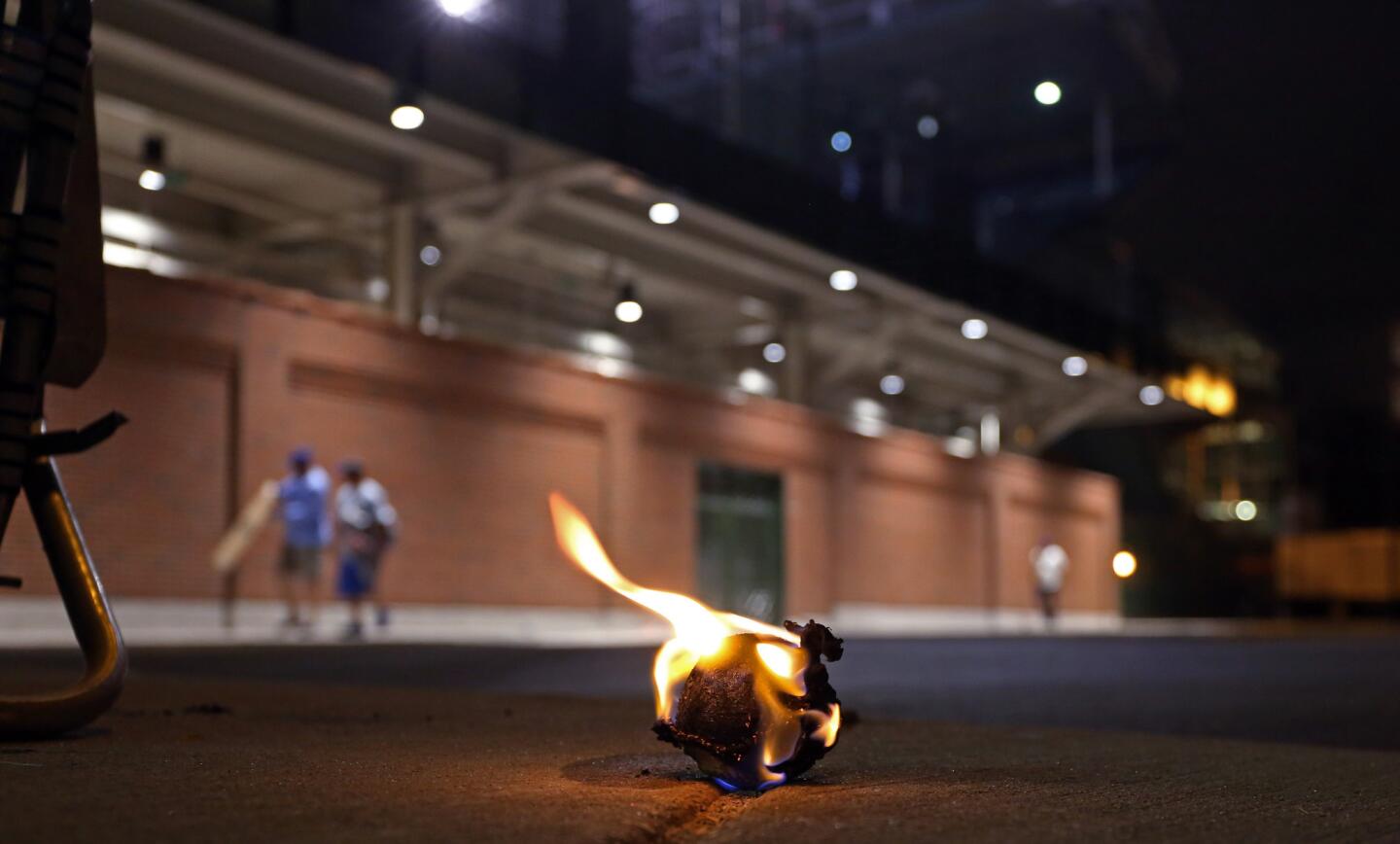 Ballhawks burn a baseball Kris Bryant hit onto Waveland Avenue during batting practice, in what they said was a 17-year-old tradition outside Wrigley Field.