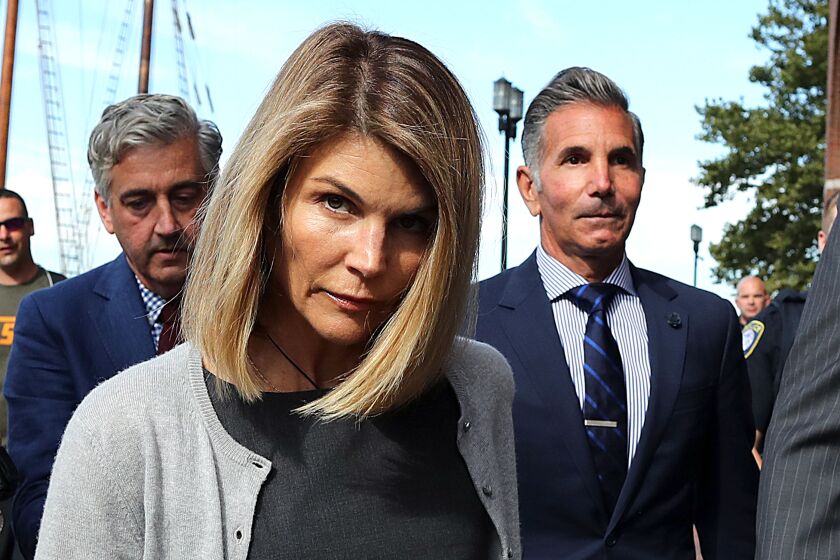  Lori Loughlin and her husband Mossimo Giannulli, right, leave the courthouse in Boston