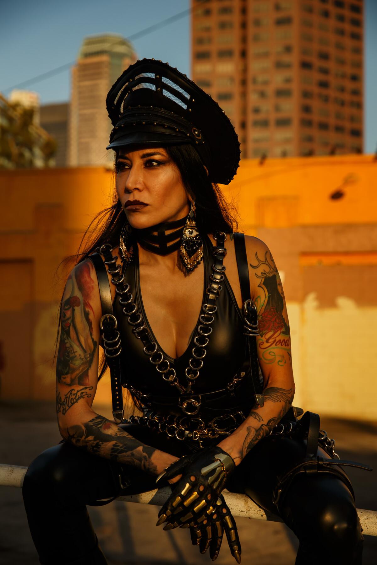 Artist Lizz Lopez poses for a portrait before her solo exhibition "Muerte" at Lethal Amounts in Los Angeles.