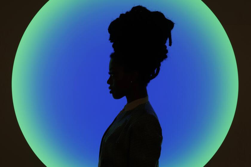 LOS ANGELES, CALIFORNIA—FEB. 12, 2020—Standing in front of work by artist James Turrell, Amiraa Vee, of Washington D.C. is a fashion designer. She is attending Frieze this year “So far, so good, she said about the show. “I’m amazed by all of the diversity of the work.” Thousands attend Frieze 2020 in Los Angeles, California, Feb. 12, 2020. (Carolyn Cole/Los Angeles Times)