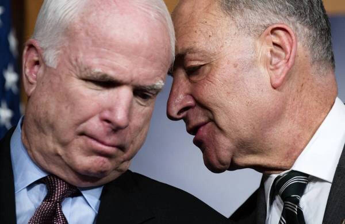 Sens. John McCain (R-Ariz.), left, and Charles E. Schumer (D-N.Y.) confer at a news conference in which they expressed optimism about an immigration overhaul proposal.