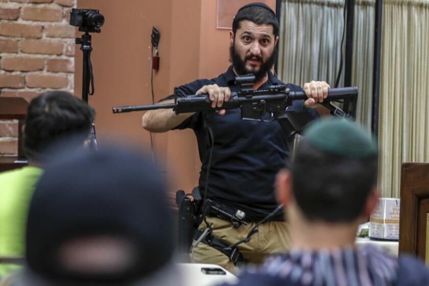 LOS ANGELES, CA, WEDNESDAY, MAY 8, 2019 -- Raziel Cohen holds an AR-15 rifle while delivering information and tips on how to deal with an "active shooter," to members of the Congregation Bais Bezalel Synagogue. (Robert Gauthier/Los Angeles Times)