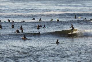 MALIBU, CA - MAY 13: Surfers take advantage of the low tide swell at Malibu Surfrider Beach next to the Malibu Pier Wednesday morning as Los Angeles County Beaches reopened for active use only. The beaches have been closed for two months due to the coronavirus Covid-19 pandemic and remained off limits even as the coastline reopened for active use in Orange County. Beachgoers will have to wear masks and maintain a six-foot buffer between themselves and others under continued social distancing requirements. Parking lots, piers and boardwalks will remain closed. Malibu Pier on Wednesday, May 13, 2020 in Malibu, CA. (Al Seib / Los Angeles Times)