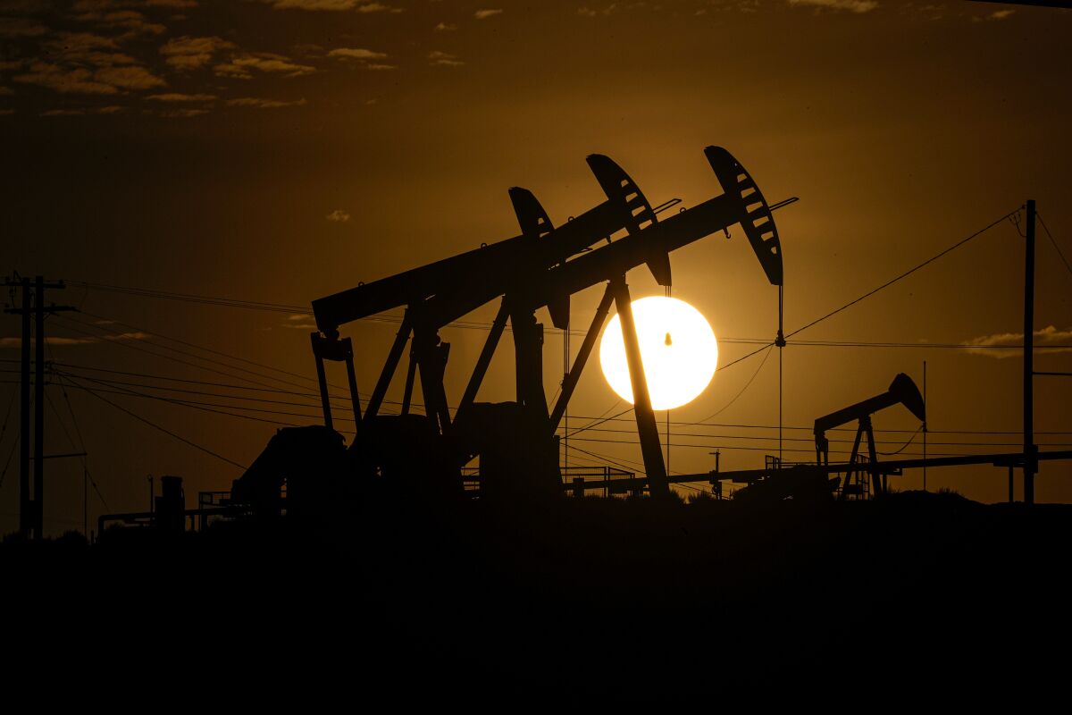 The sun sets over the Cymric oil field in McKittrick, Calif.