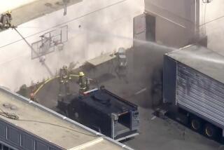 Fire crews try to suppress a fire inside a trailer at the Pitchess Detention Center in Castaic, where several deputies were injured Tuesday morning in what authorities described as a training incident.