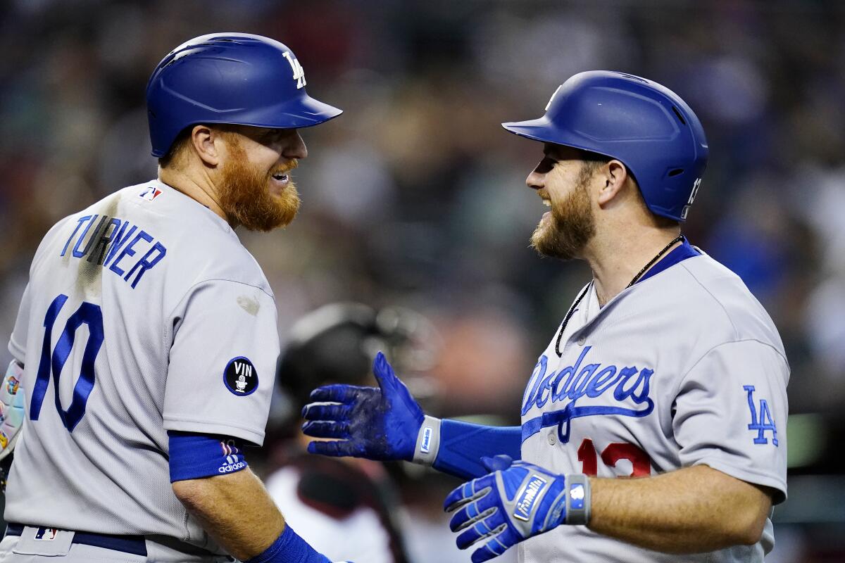 The Dodgers' Max Muncy smiles as he celebrates his home run against the Diamondbacks 