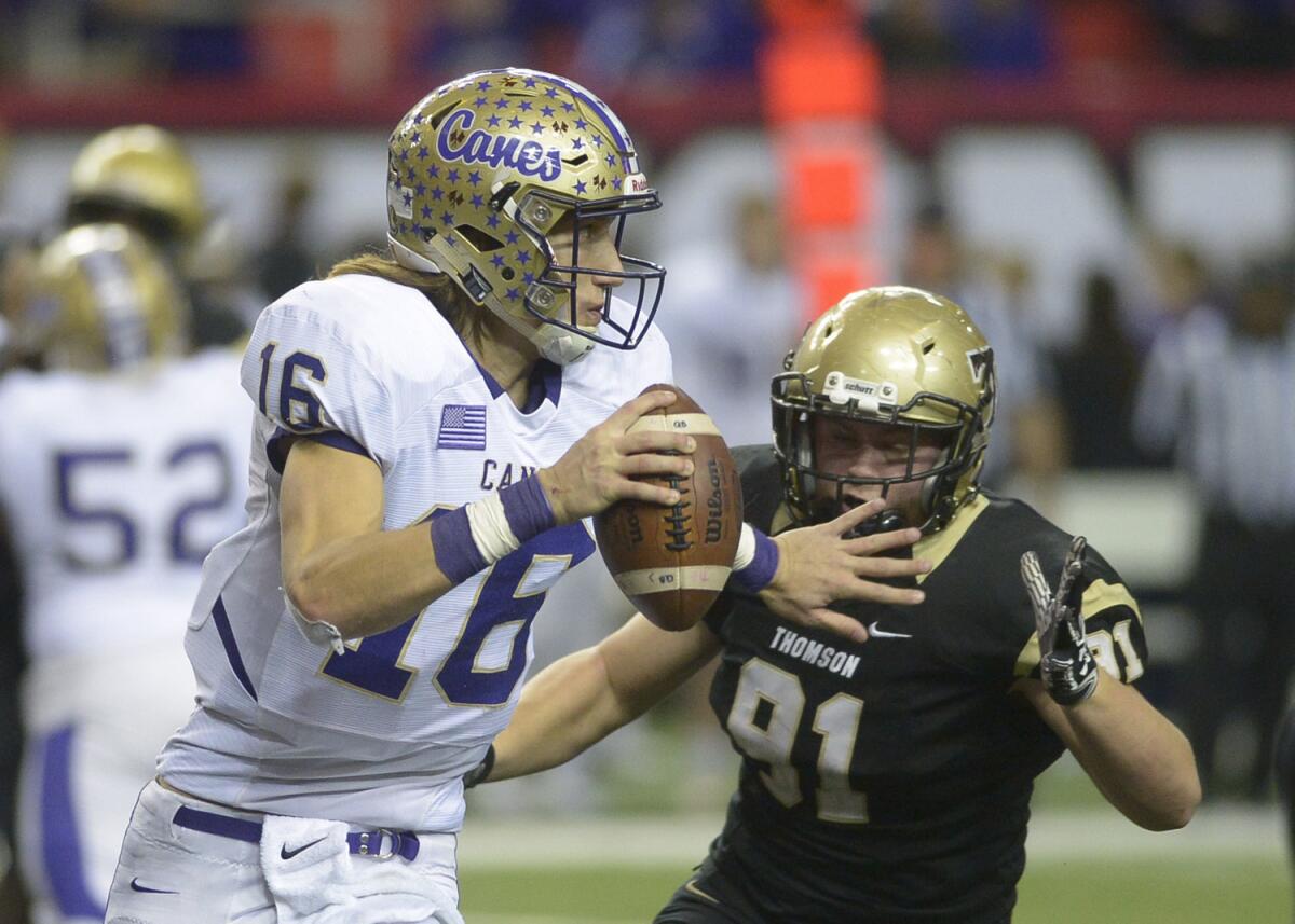 Cartersville quarterback Trevor Lawrence (16) is pressured by Thomas' Will Roberts (91) during a Class AAAA championship football game in Atlanta on Dec. 10, 2016.