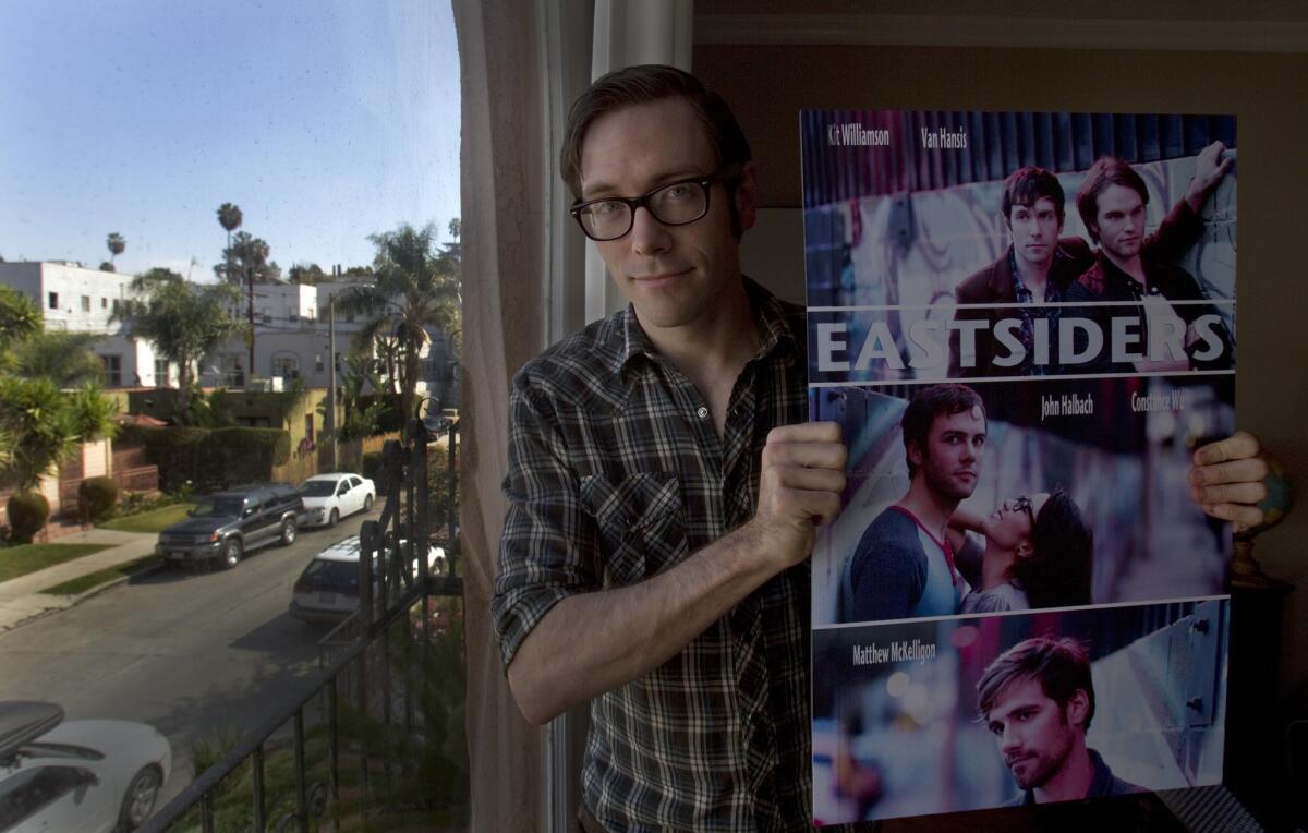 Kit Williamson holds a poster of his Web series, "The Eastsiders," at his Silver Lake home. He is very connected to the Eastside name. But, he said, "I would never say Boyle Heights and those other areas are not the Eastside. That would be hurtful and should be avoided. The term is big enough it could be applied to both places."