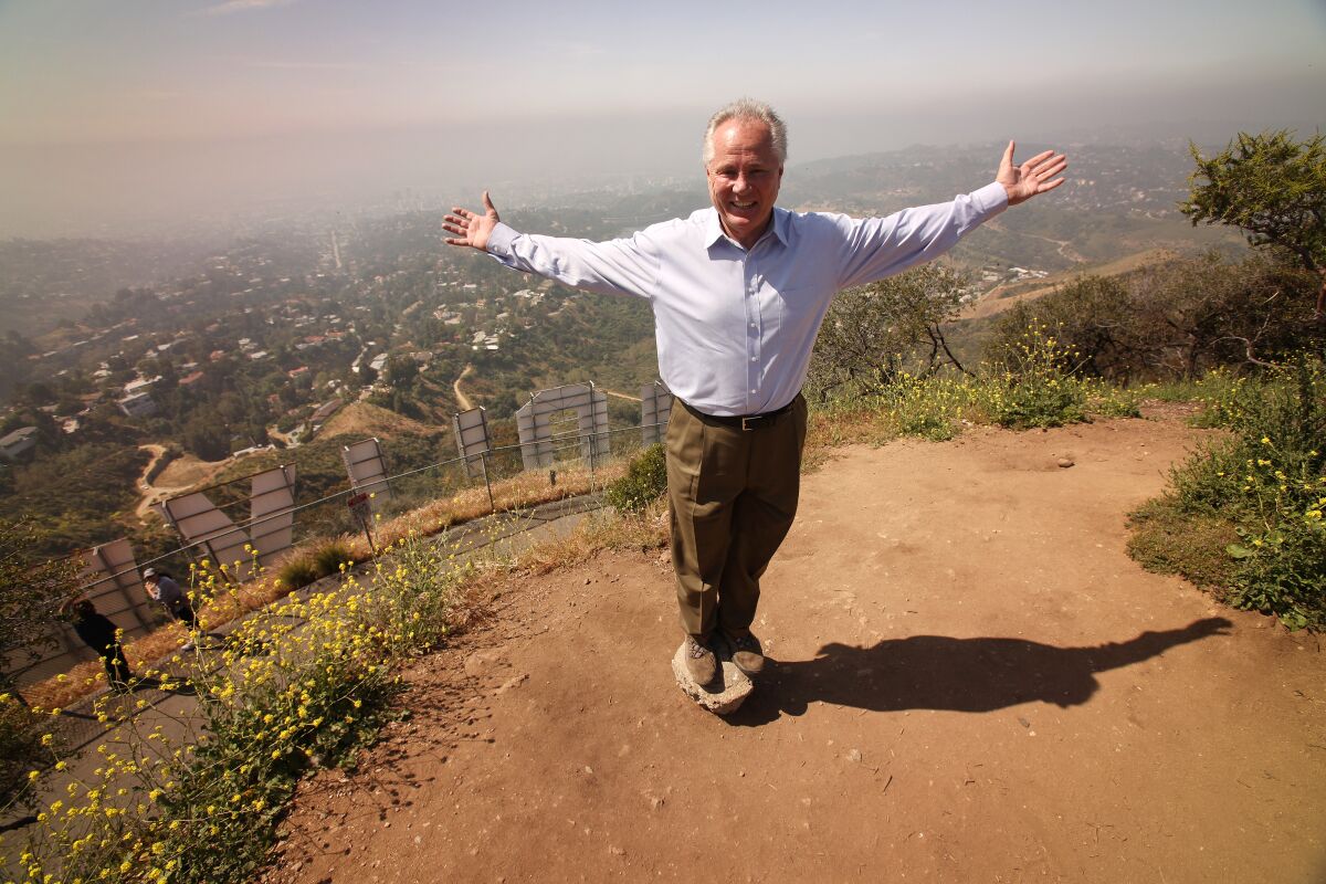 On April, 26, 2010, Tom LaBonge stands near the top of Mount Lee above the Hollywood sign.
