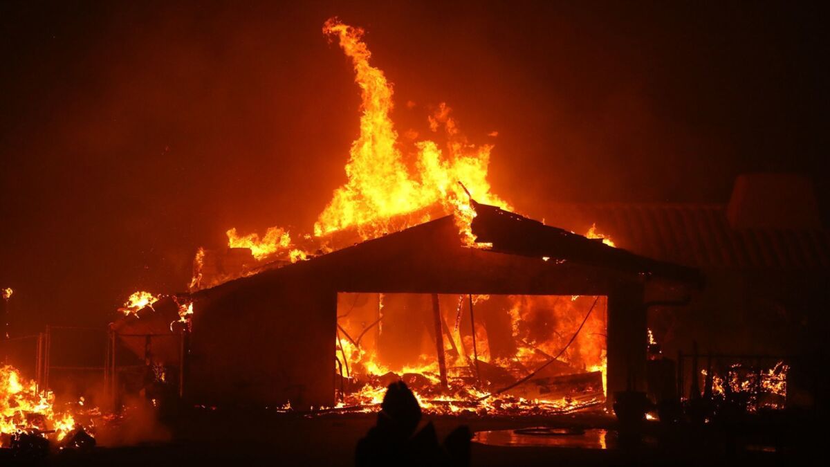 A home is consumed by the Woolsey fire along the Pacific Coast Highway on Friday in Malibu.