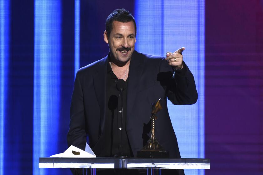 Adam Sandler accepts the award for best male lead for "Uncut Gems" at the 35th Film Independent Spirit Awards on Saturday, Feb. 8, 2020, in Santa Monica, Calif. (AP Photo/Chris Pizzello)