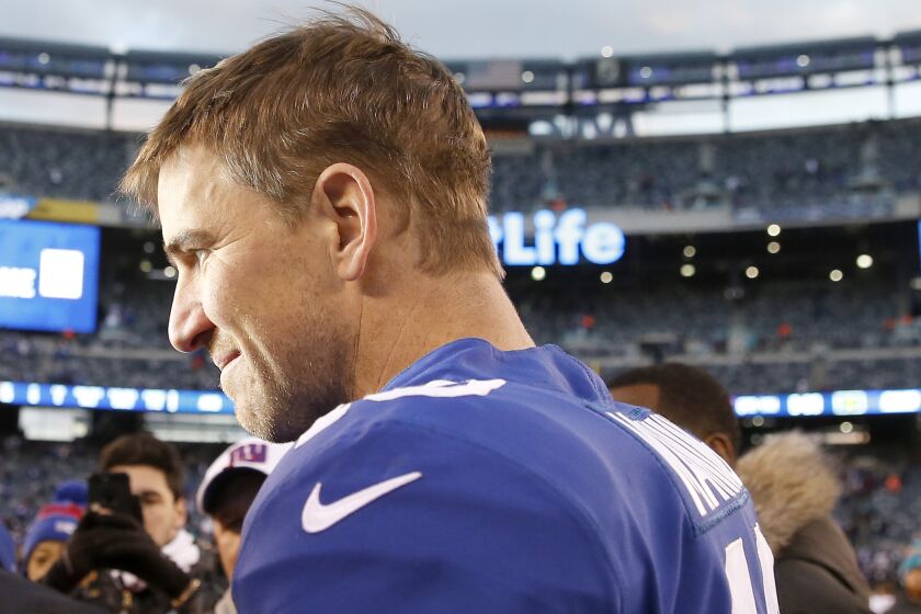 EAST RUTHERFORD, NEW JERSEY - DECEMBER 15: Eli Manning #10 of the New York Giants is interviewed on the field after the game against the Miami Dolphins at MetLife Stadium on December 15, 2019 in East Rutherford, New Jersey.The New York Giants defeated the Miami Dolphins 31-13. (Photo by Elsa/Getty Images)