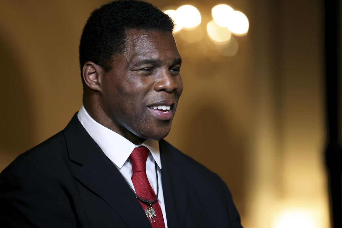FILE - Herschel Walker speaks to members of the media after his Republican Primary win on Tuesday, May 24, 2022, at the Georgian Terrace Hotel in Atlanta. Walker will represent the Republican Party in its efforts to unseat Democratic Sen. Raphael Warnock in November. (Jason Getz/Atlanta Journal-Constitution via AP, File)
