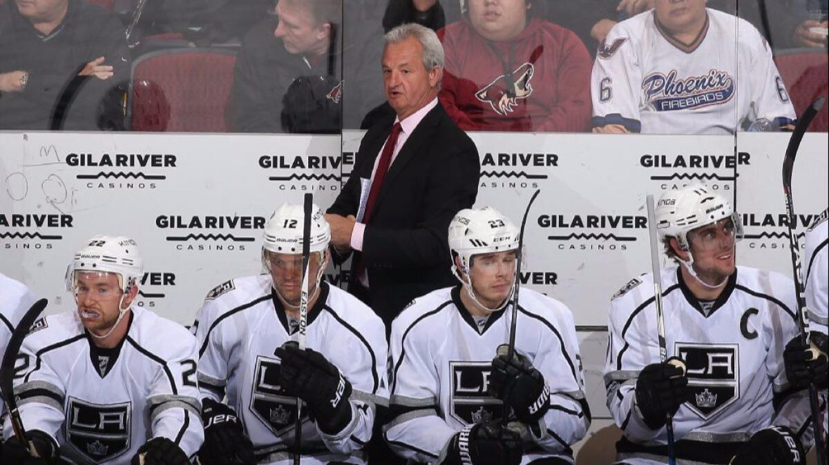 Kings Coach Darryl Sutter watches from the bench during the first period of a game against the Coyotes on Jan. 31.