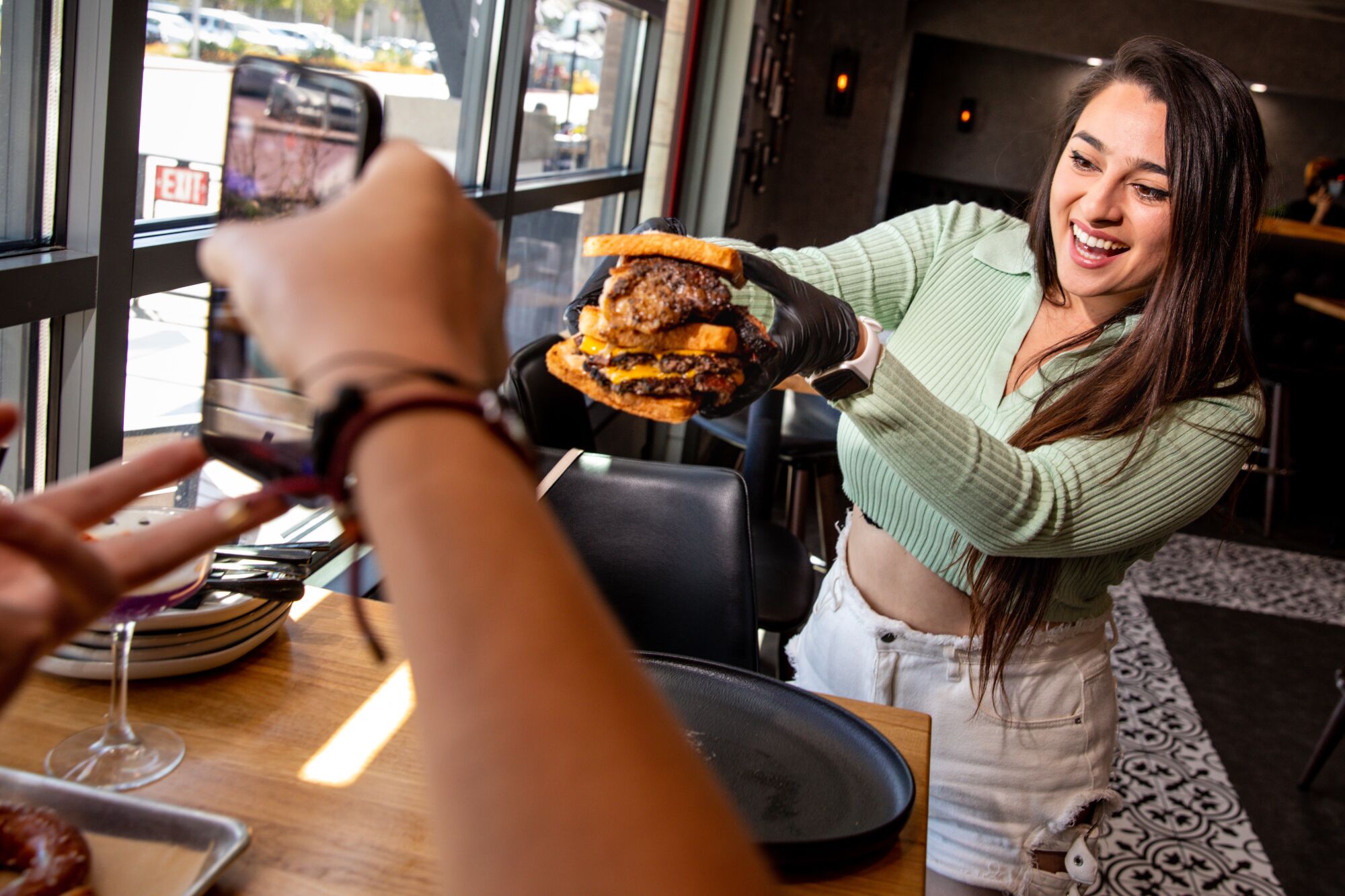 Ashley Rodriguez holds up food in front of a phone