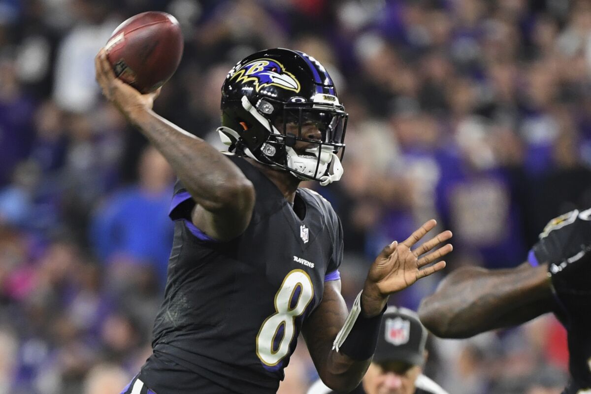 FILE - Baltimore Ravens quarterback Lamar Jackson (8) passes the ball during the second quarter of an NFL football game against the Indianapolis Colts, in Baltimore, Md., in this Monday, Oct. 11, 2021, file photo. The criticism of Lamar Jackson's passing ability should be awfully quiet right now after the Baltimore quarterback led the Ravens to another dramatic victory -- and threw for over 400 yards for the first time in his career. (AP Photo/Terrance Williams, File)