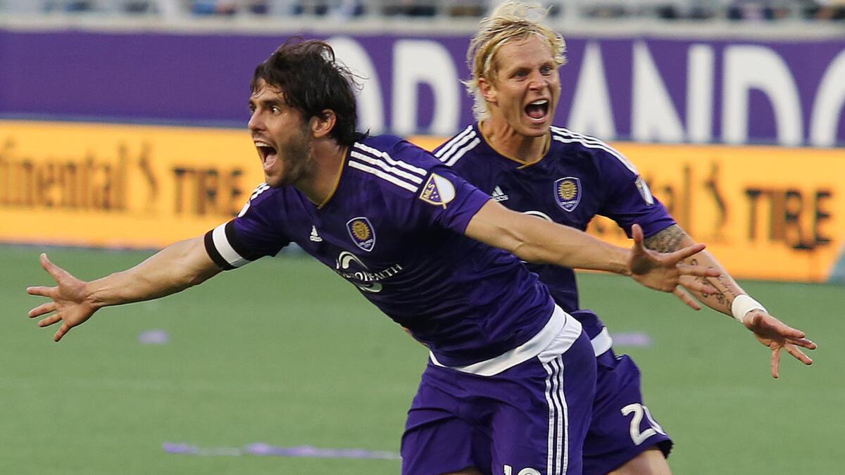 Orlando City's Kaka, front, celebrates with teammate Brek Shea after scoring the tying goal in stoppage time of a 1-1 draw with New York City on March 8.