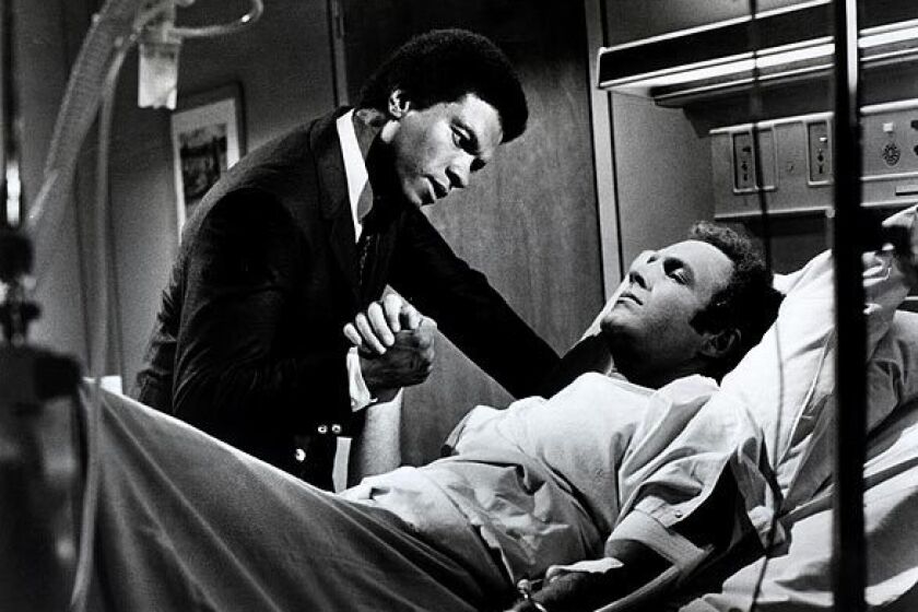 Gale Sayers (Billy Dee Williams) comforts Brian Piccolo (James Caan) in 1971's "Brian's Song," our No. 10 film. Buzz Kulic directed the true-life story about the friendship between Sayers and Piccolo, who died at age 26.