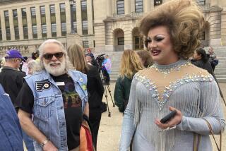 Drag performer Poly Tics, right, attends a rally in Frankfort, Ky., on Thursday, March 2, 2023. She spoke earlier at a legislative committee hearing where she opposed a bill that would put limits on drag shows in Kentucky. (AP Photo/Bruce Schreiner)