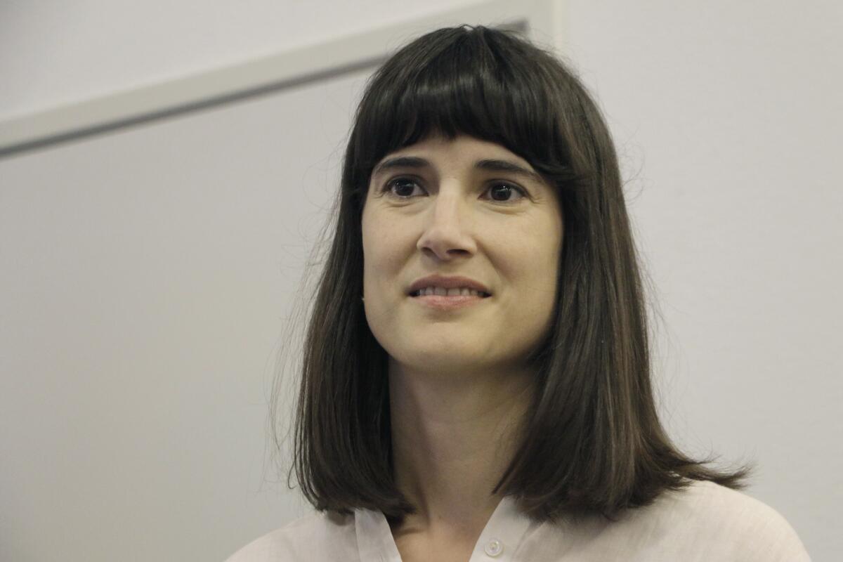 A closeup of a woman with shoulder-length dark hair