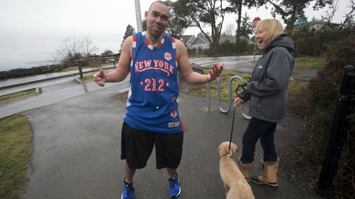 Lamont Thomas chats with Kim Vande Griend in Shoreline, Wash., during a run. "You're a great inspiration to a lot of people," she told him.