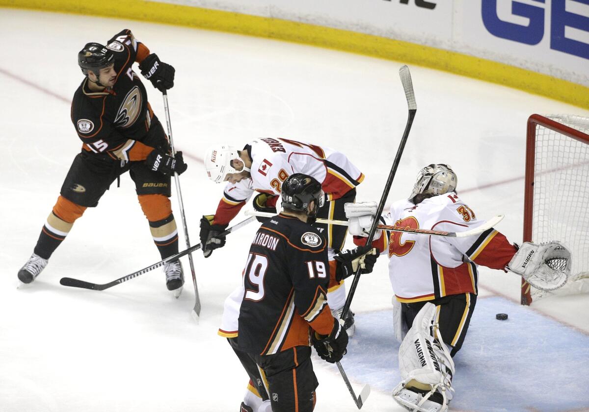 Ryan Getzlaf, left, shoots to score against Calgary goalie Karri Ramo during the third period Thursday night in Anaheim.