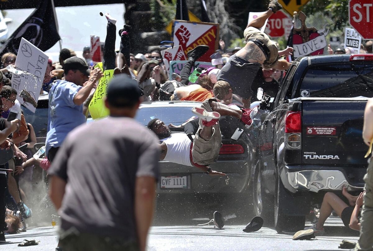 Some are thrown in the air as a car runs through a crowd of protesters at a 2017 white nationalist rally in Charlottesville, Va.