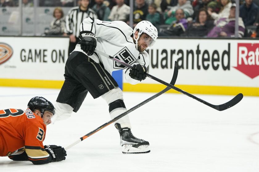 Los Angeles Kings' Anze Kopitar, right, shoots as Anaheim Ducks' Jakob Silfverberg.