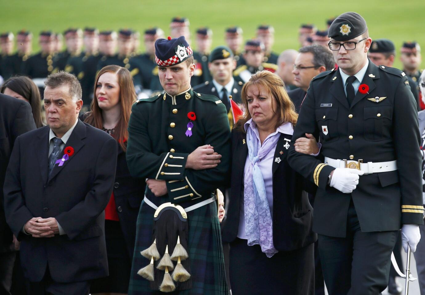 Soldiers escort Kathy Cirillo (2nd R) during the funeral procession for her son Cpl. Nathan Cirillo in Hamilton, Ontario October 28, 2014.
