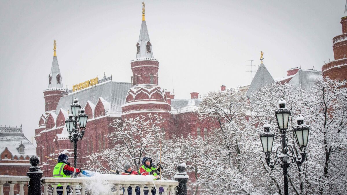 Municipal workers shovel snow on Manezhnaya Square outside the Kremlin during a heavy snowfall in Moscow on Jan. 31.
