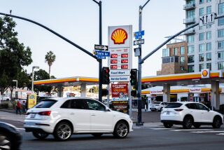 San Diego, CA - October 03: Cars zoom by the intersection of 11th Street and A Street in downtown in San Diego, CA on Monday, Oct. 3, 2022. Gas prices have climb over to $7 a gallon in San Diego. (Adriana Heldiz / The San Diego Union-Tribune)