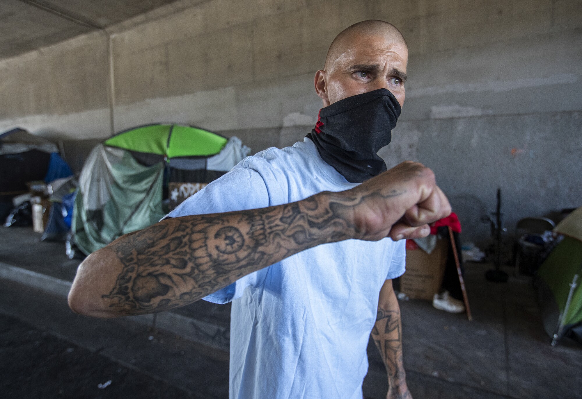 Lance Matson visits friends at a homeless encampment on Corbin Avenue underneath the 101 Freeway in Tarzana.