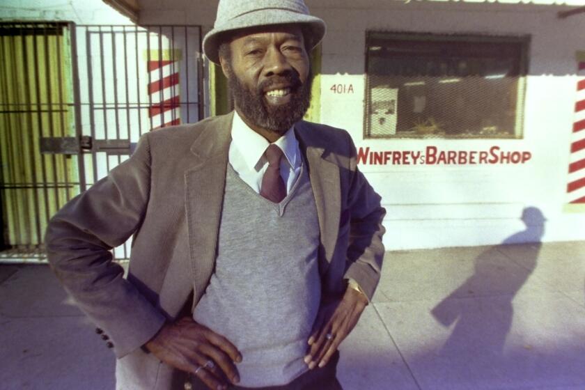 Vernon Winfrey, father of Oprah Winfrey, stands outside his barber shop in Nashville, Tenn., in 1987.