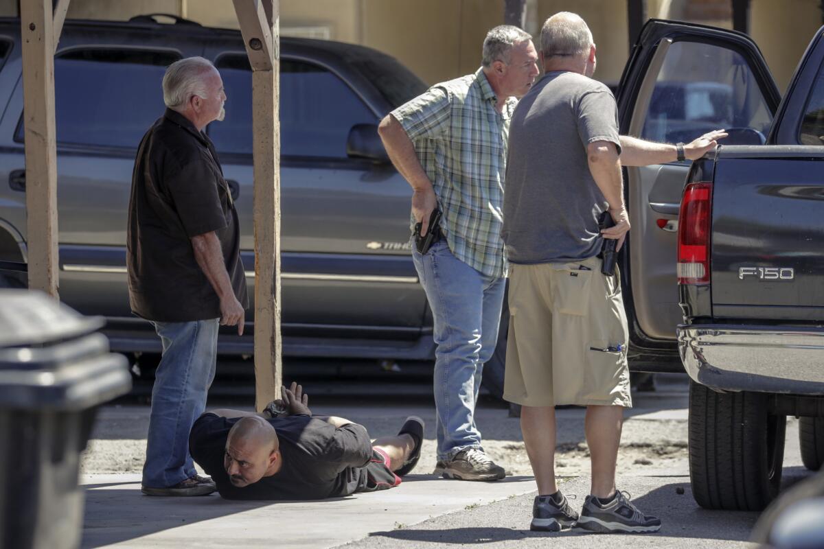 Investigator Marc Bender, left, is one of the handful of bail agents calling for more oversight. Above he takes into custody a man accused of failing to comply with the conditions of bail.