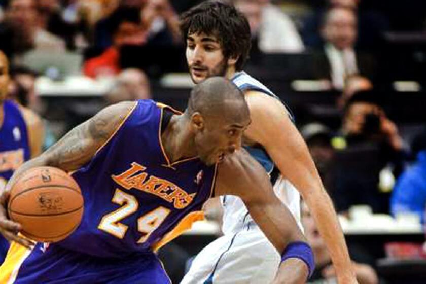 Lakers guard Kobe Bryant drives against Wolves guard Ricky Rubio during a game last season.