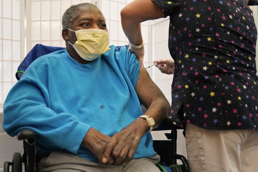 A man receives a COVID-19 booster shot.