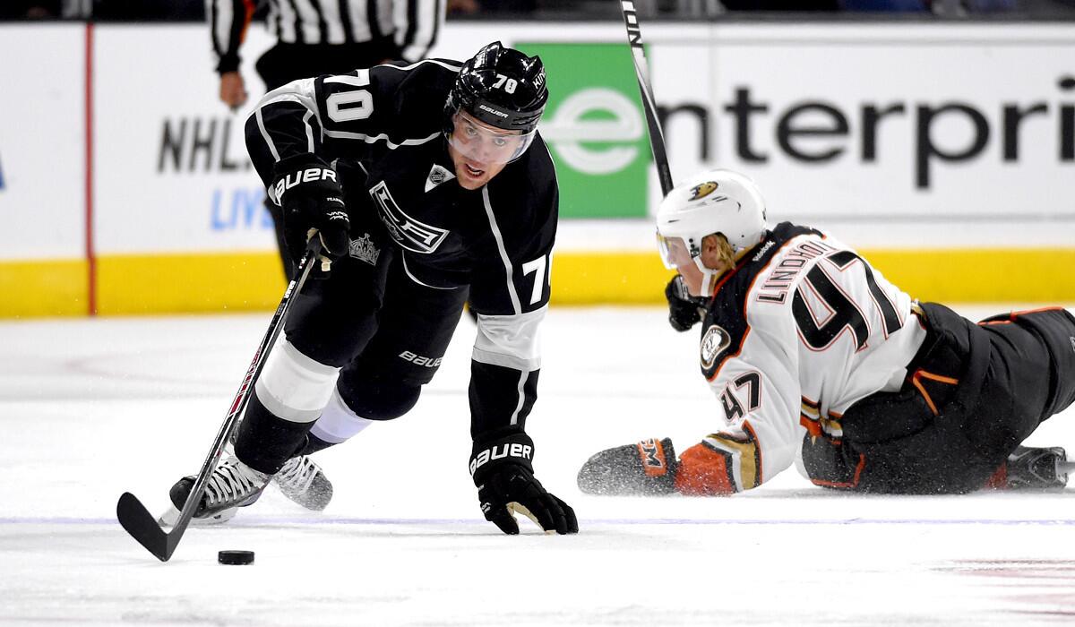 Kings left wing Tanner Pearson (70) takes the puck away from fallen Ducks defenseman Hampus Lindholm in the second period of a preseason game Thursday night at Staples Center.