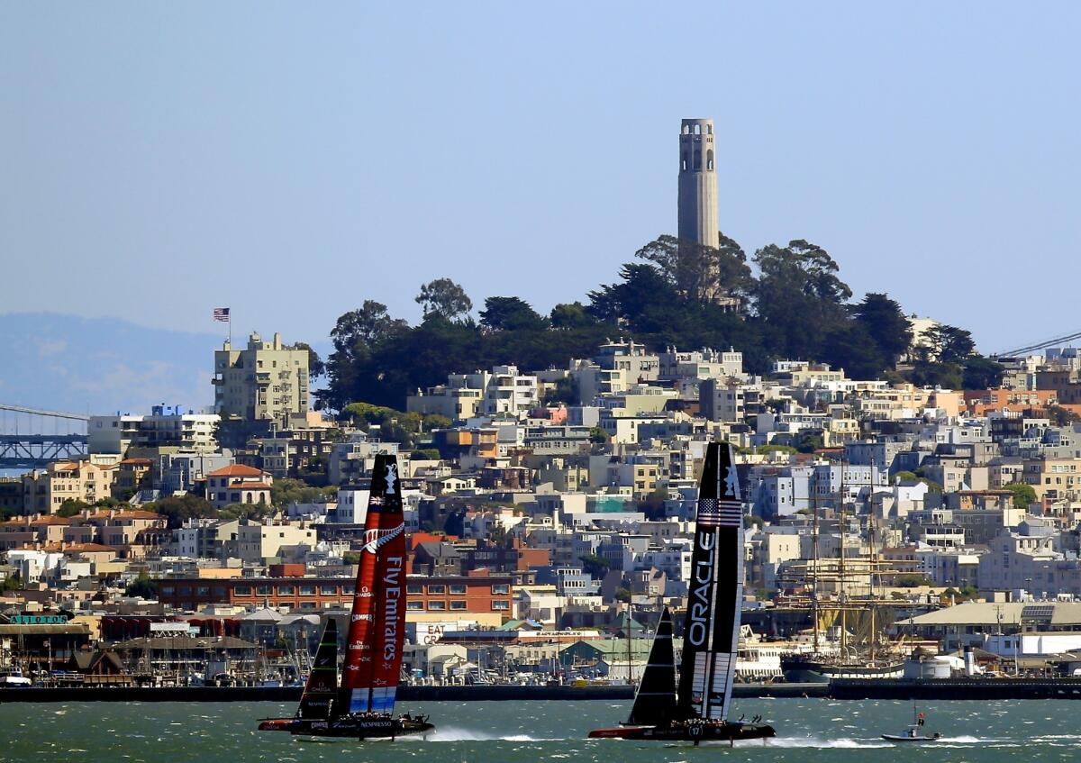 Emirates Team New Zealand, left, and Oracle Team USA compete in Race 10 of the America's Cup in San Francisco Bay on Sunday.