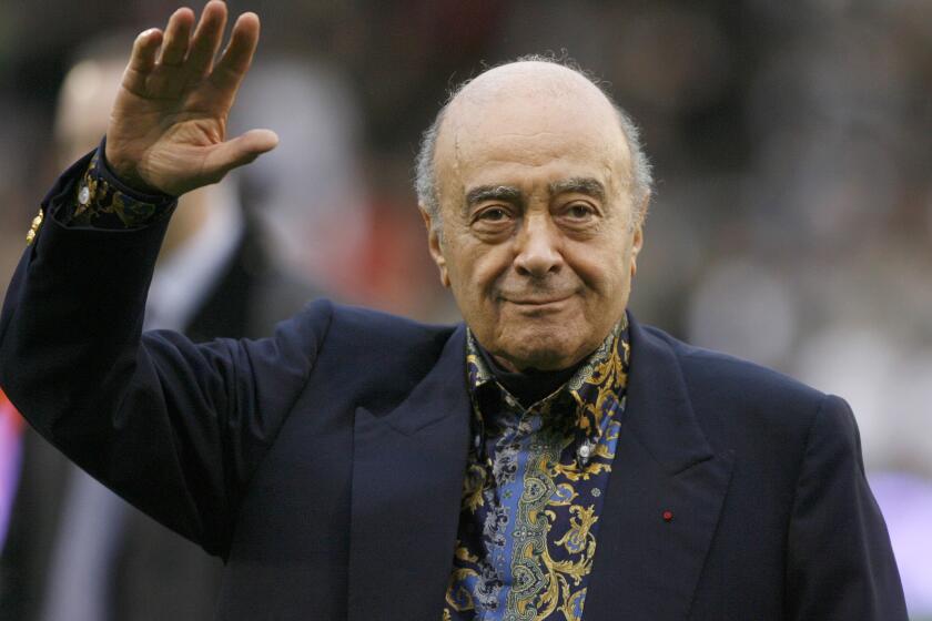 FILE - Fulham owner Mohamed Al-Fayed waves to the crowd before the English Premier League soccer match against Tottenham Hotspur at Craven Cottage stadium, London, Nov. 15, 2008. Al-Fayed, the former Harrods owner whose son Dodi was killed in a car crash with Princess Diana, has died at age 94. His death was announced Friday, Sept. 1, 2023, by Fulham Football Club, which Al-Fayed once owned. (AP Photo/Simon Dawson, File)