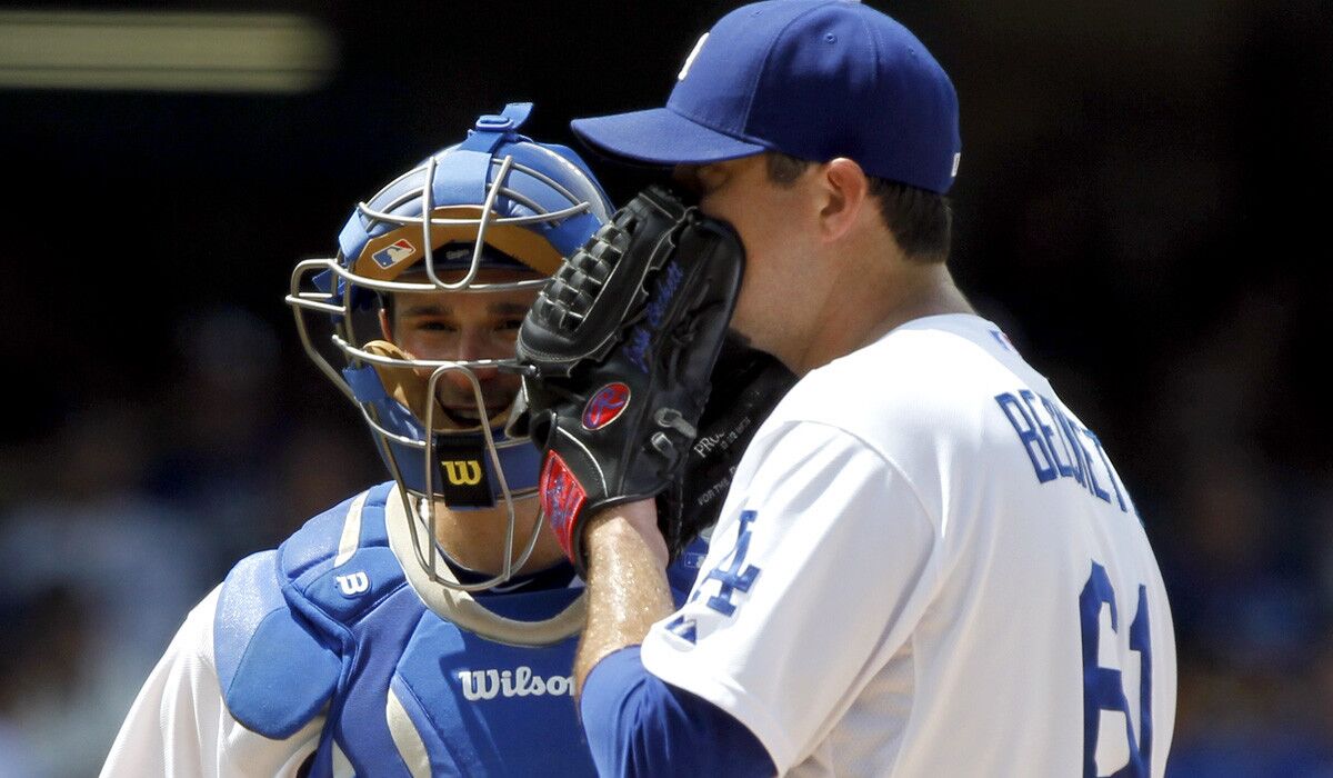 Dodgers starting pitcher Josh Beckett discusses strategy with catcher Drew Butera in the third inning of Sunday's game against the Chicago Cubs. Beckett failed to make it out of the fifth inning for a third consecutive start.