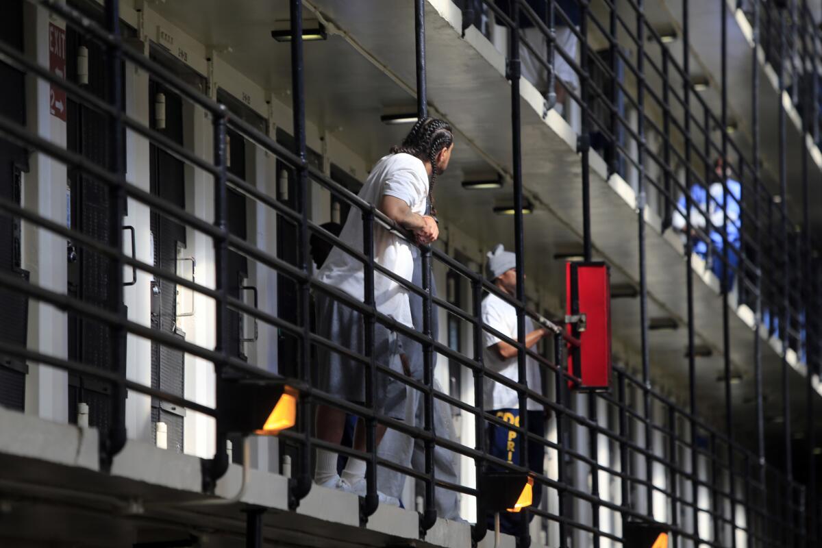 Inmates walk around in one of the cellblocks at San Quentin State Prison in 2014. One inmate at the prison was diagnosed with Legionnaires' disease and several others are showing symptoms, prison officials said.