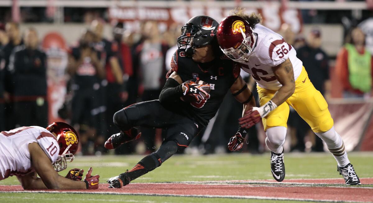 USC linebacker Anthony Sarao, right, tackles Utah receiver Dres Anderson last October.