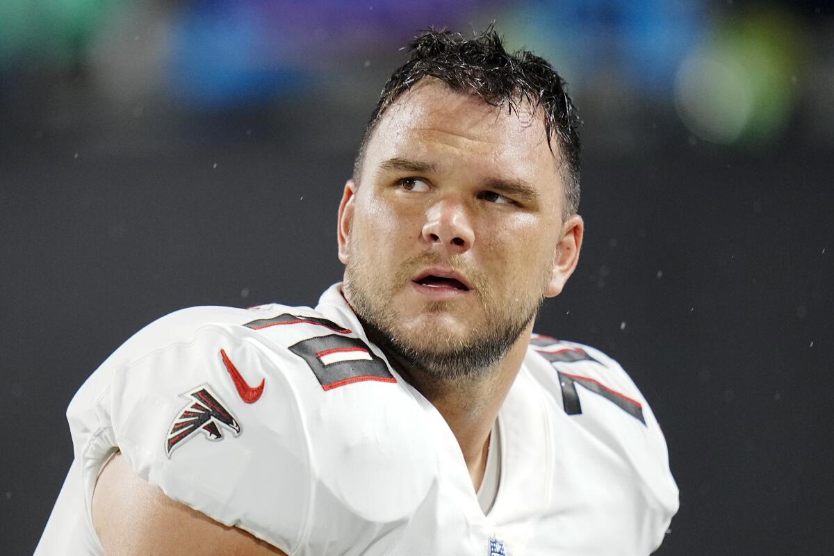 Atlanta Falcons offensive tackle Jake Matthews watches during warm ups before an NFL football game between the Carolina Panthers and the Atlanta Falcons on Thursday, Nov. 10, 2022, in Charlotte, N.C. (AP Photo/Rusty Jones)