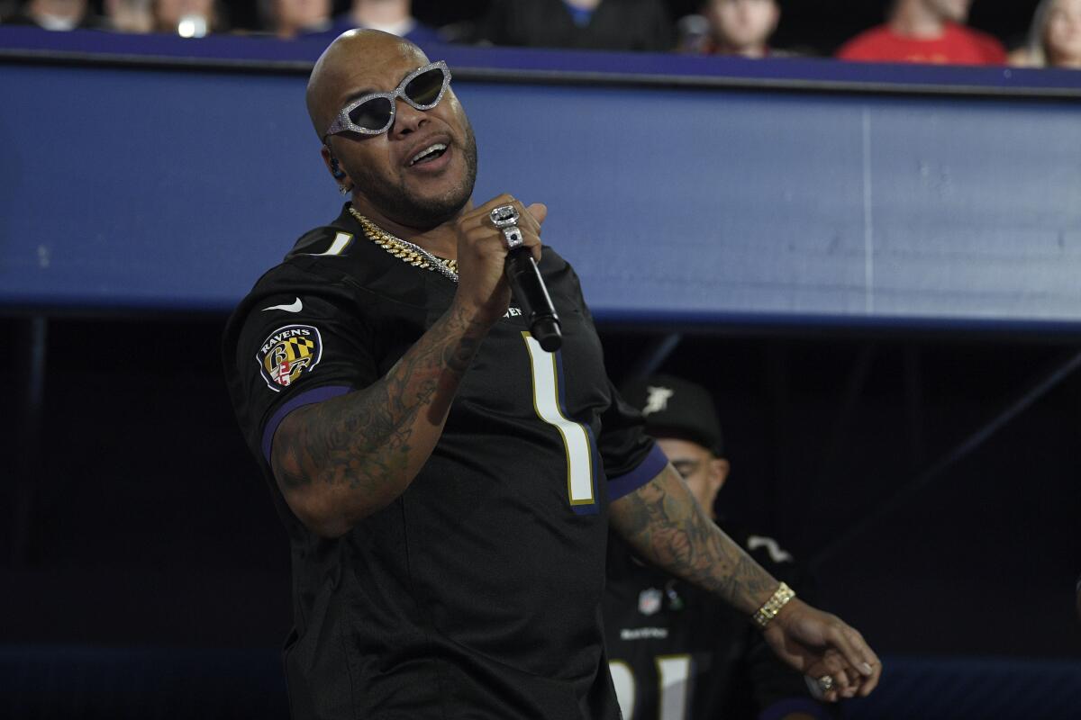 Rapper Flo Rida performs during a halftime at a football game