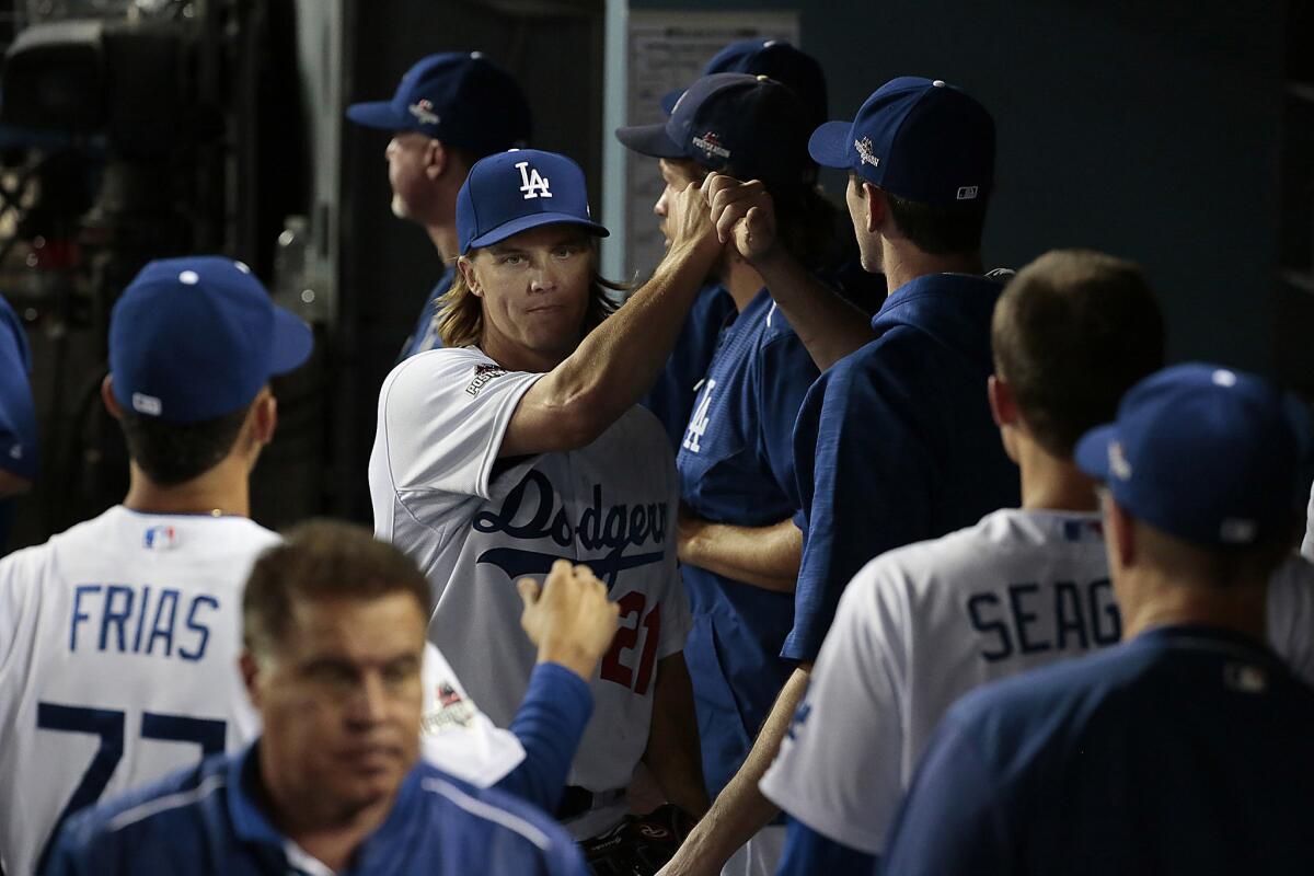 Zack Greinke is congratulated by his teammates after seven innings of work. Greinke gave up two runs on five hits with eight strikeouts in the Dodgers' 5-2 win over the Mets.