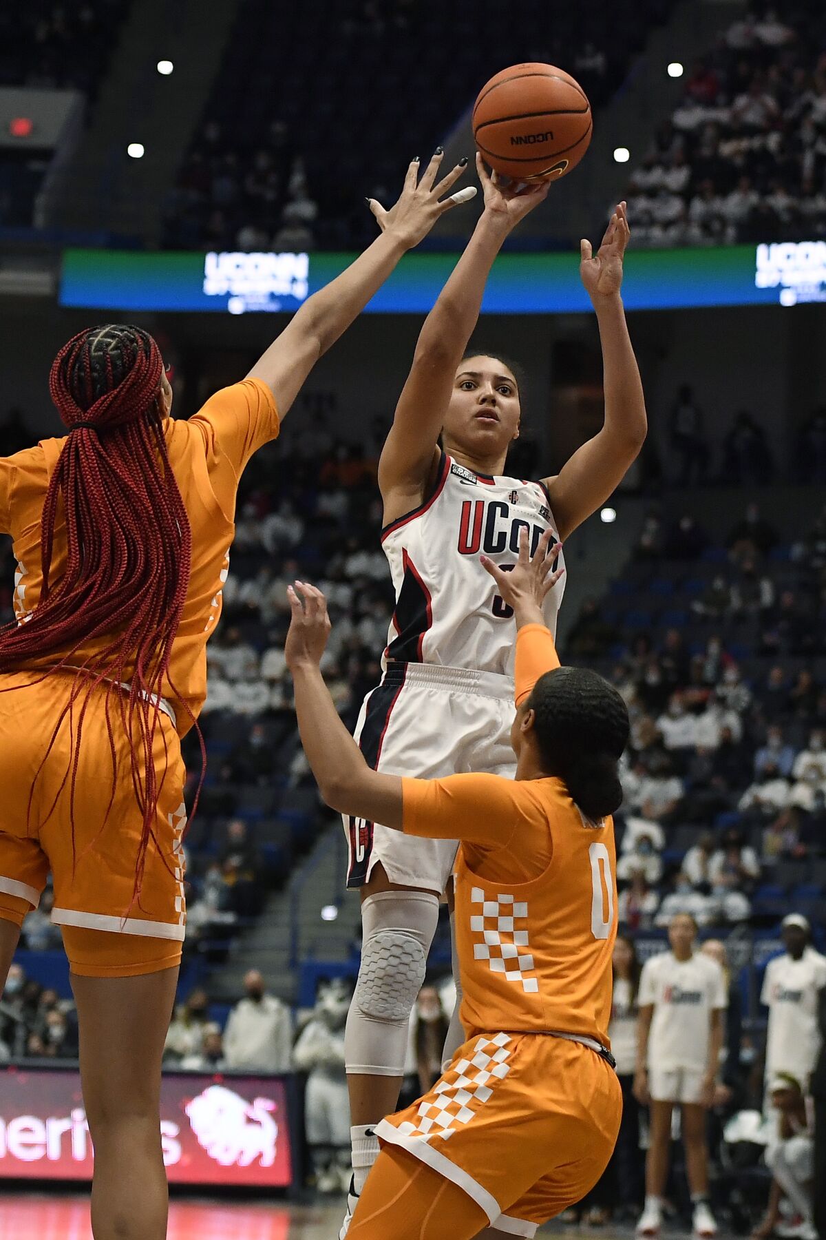 Connecticut's Azzi Fudd shoots over Tennessee's Tamari Key, left, and Tennessee's Brooklynn Miles, right, in the first half of an NCAA college basketball game, Sunday, Feb. 6, 2022, in Hartford, Conn. (AP Photo/Jessica Hill)
