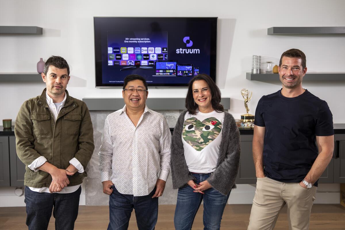 Thomas Wadsworth, Eugene Liew, Lauren DeVillier and Paul Pastor stand inside Liew's home office in Los Angeles