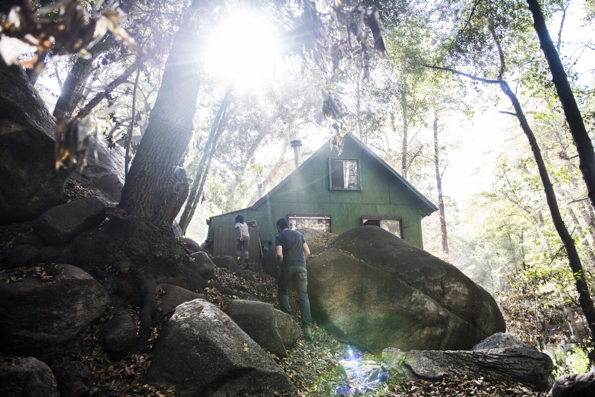Members of the Jeevanjee family walk up to their cabin in Big Santa Anita Canyon.