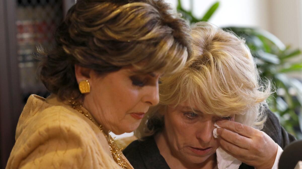 Heather Kerr, right, who alleges that she was sexually harassed by Harvey Weinstein, wipes away a tear after addressing the media with her attorney Gloria Allred during a press conference at Allrred's office.